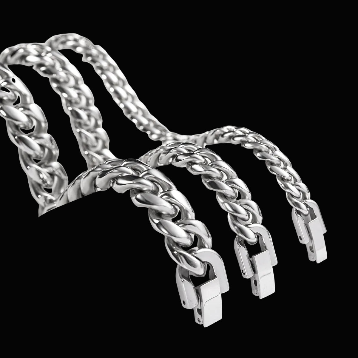 Three silver-toned chunky curb chain necklaces draped over a white display stand on a clean white background.